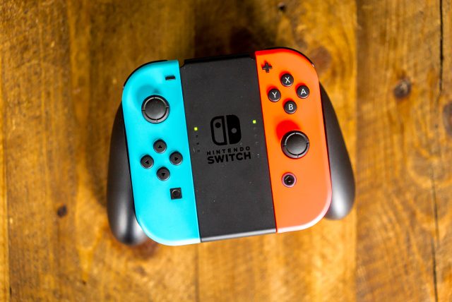 The Switch'S Joy-Con Controllers In Their Cradle.