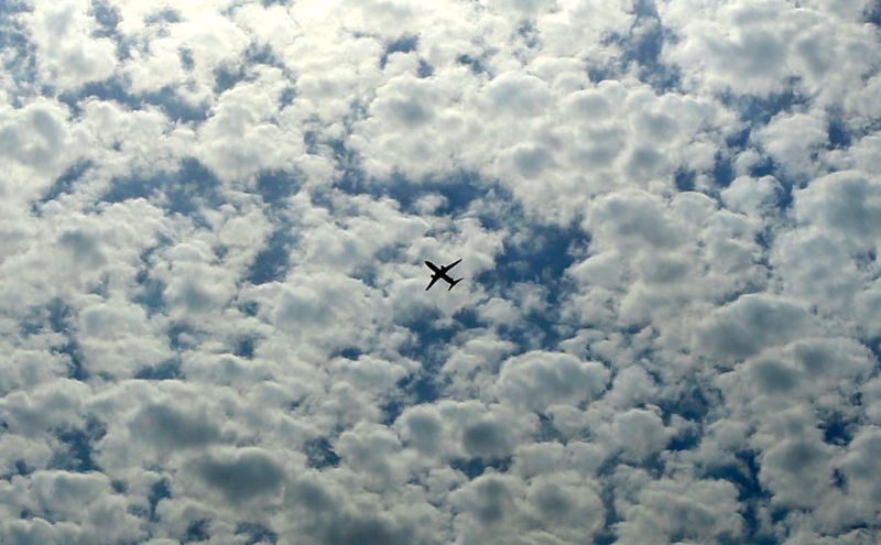 A commercial airliner flies over the Kuwait City on January 11, 2017, after taking off from Kuwait's International Airport.