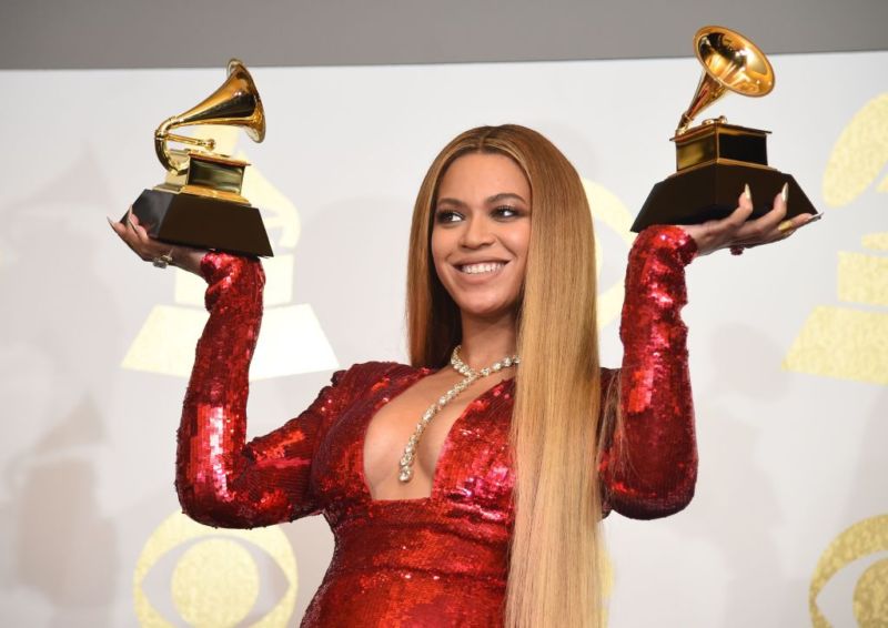 Beyonce poses with her Grammy trophies in the press room during the 59th Annual Grammy music awards on February 12, 2017, in Los Angeles, California. Unauthorized use of her images has prompted litigation over the DMCA's "safe harbor" provision.