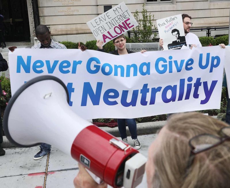 Protestors object to FCC Chairman Ajit Pai's plan to eliminate net neutrality rules before Pai's appearance at the American Enterprise Institute in Washington, DC, on May 5, 2017.
