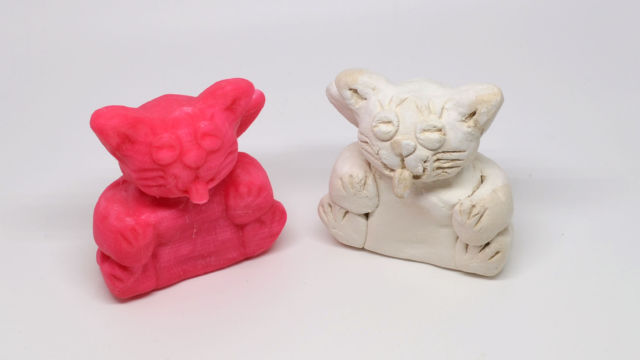 The final model (left) printed in PLA on the MOD-t. The Matter and Form 3D Scanner produced the closest reproduction of the original clay cat model (right) out of any of the solutions in this roundup.