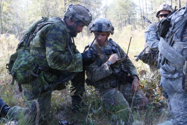 Canadian Armed Forces Master Corporal James Dowson (left), a section leader with the Lake Superior Scottish Regiment, and US Army 1st Lt. Travis Hines, a platoon leader with Alpha Company, 3rd Battalion, 7th Infantry Regiment, 2nd Infantry Brigade Combat Team, 3rd Infantry Division, plan their next movement during Bold Quest at Fort Stewart, Georgia, October 31, 2016.