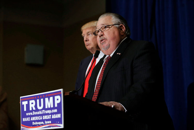 Sam Clovis, then-newly appointed national co-chair of the Trump campaign, speaks with Donald Trump at a news conference.