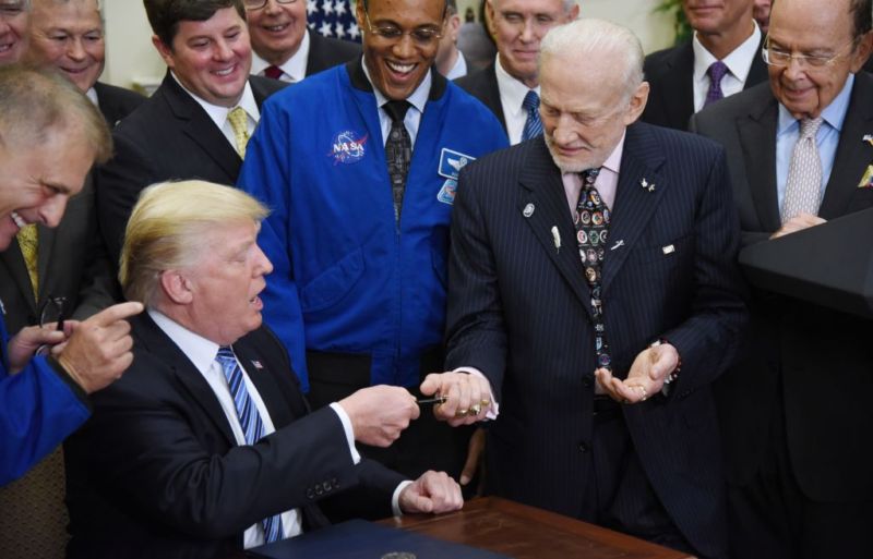 President Donald Trump gives the pen to Buzz Aldrin after signing an Executive Order to reestablish the National Space Council in June.