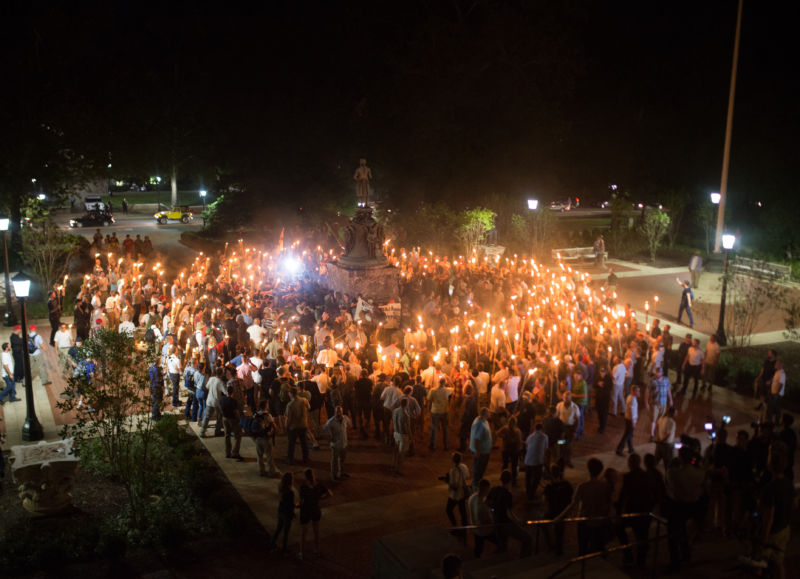 Neo Nazis, Alt-Right, and White Supremacists encircle counter protestors at the base of a statue of Thomas Jefferson after marching through the University of Virginia campus with torches in Charlottesville, Va., USA on August 11, 2017.  Photos of marchers are being used to identify and shame them on social media.