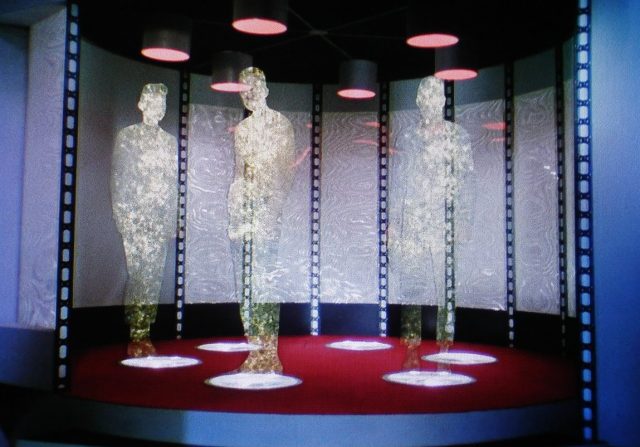 Kirk, Spock, and McCoy beam down. 