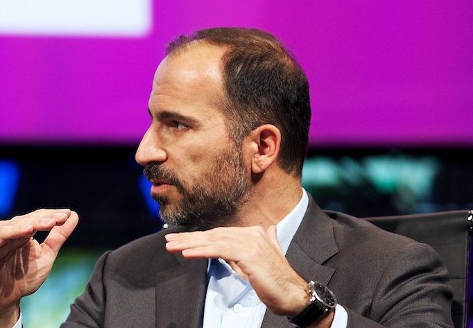 A man in an open-collared shirt during a presentation.