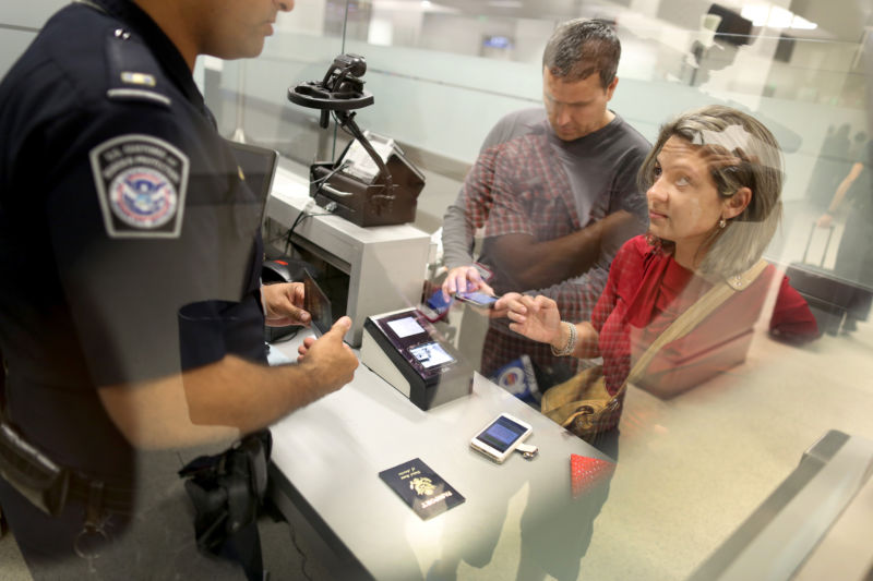 Leonel Cordova (L) and Noris Cordova, who are not plaintiffs in this lawsuit, speak to a CBP officer at Miami International Airport on March 4, 2015 in Miami, Florida.