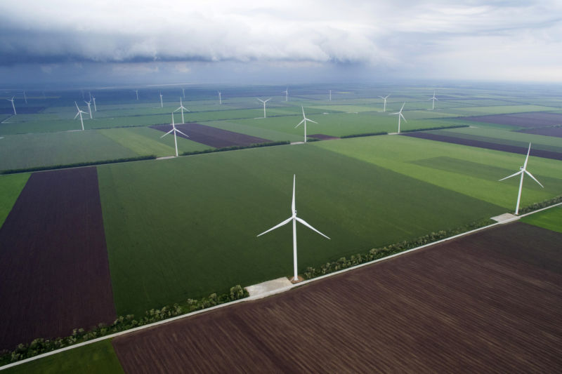 Wind turbines, manufactured by Vestas Wind Systems A/S, operate near farmland in this aerial view at the Batievo Wind Farm, operated by DTEK Holdings Ltd.  in Batievo, Ukraine, on Thursday, May 26, 2016. Photographer: Vincent Mundy/Bloomberg via Getty Images