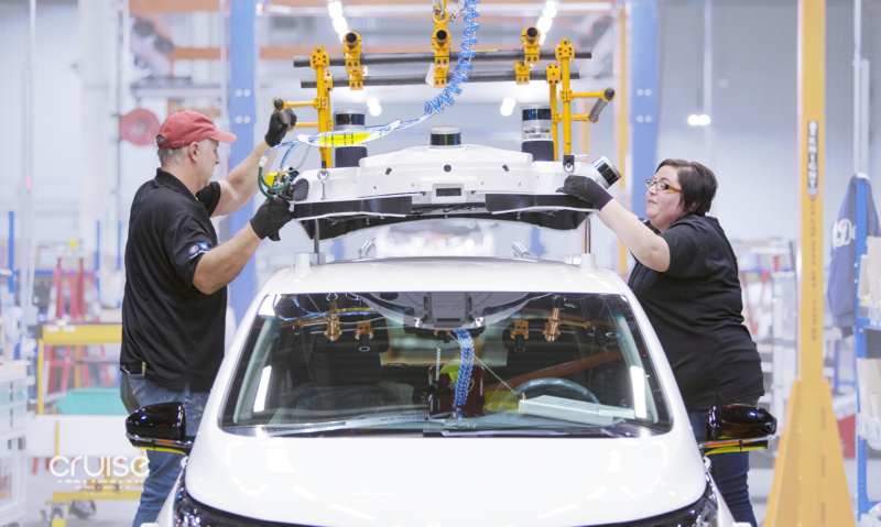 GM workers assembling a test car for Cruise.