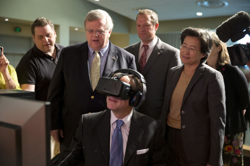 Texas Governor Greg Abbott (center) tests the Oculus virtual reality device at Advanced Micro Devices (AMD) in Austin as AMD CEO Lisa T. Su (r) watches following an Abbott bill signing that reduced Texas' franchise tax by 25 percent in June 2015.