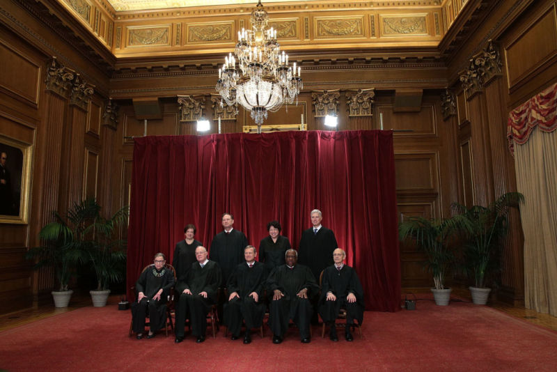 Justices pose for a group portrait in the East Conference Room of the Supreme Court. 