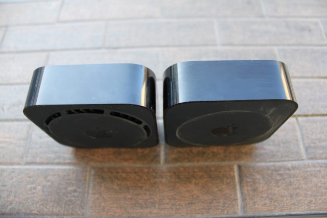 Two sandwich-sized electronic devices on a brick-style surface.