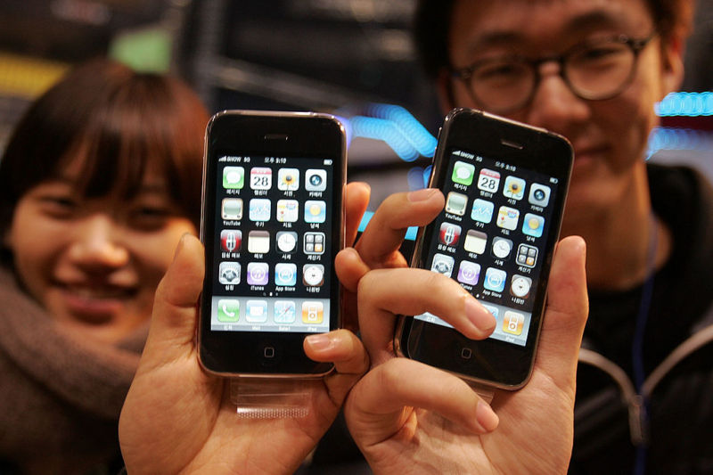 People hold their iPhone during the Apple iPhone 3G launch ceremony in Seoul, South Korea, in 2009. 