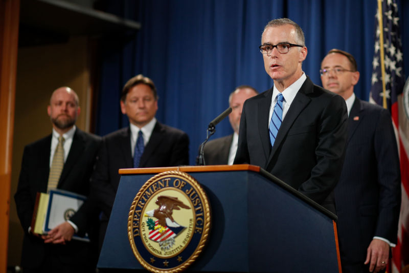 Andrew McCabe (front), then US acting director of the FBI, attends a press conference at the Department of Justice on July 20, 2017. The world's then-largest "dark market" on the Internet, AlphaBay, was shut down, DOJ officials said on that date.