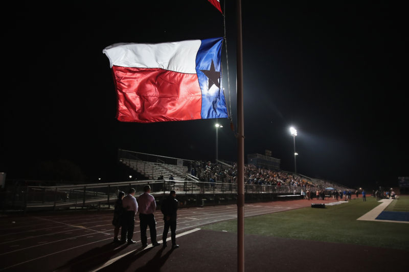 A Texas flag flies at half mast during prayer services at the La Vernia High School Football stadium to grieve the victims killed at the First Baptist Church of Sutherland Springs. 