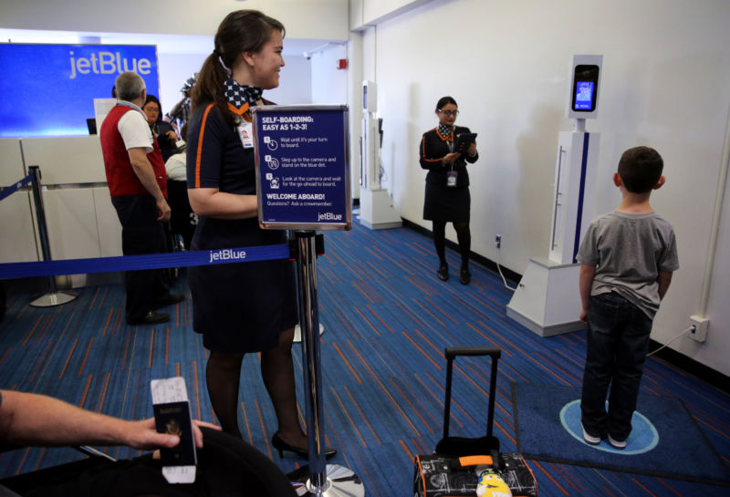 A young passenger uses JetBlue's facial-recognition system at Logan Airport in Boston on June 15, 2017.