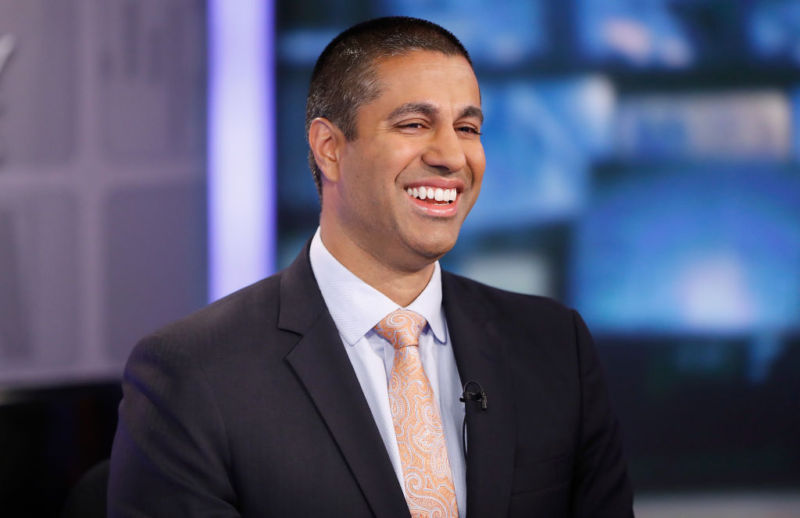 FCC Chairman Ajit Pai smiling during a TV interview.