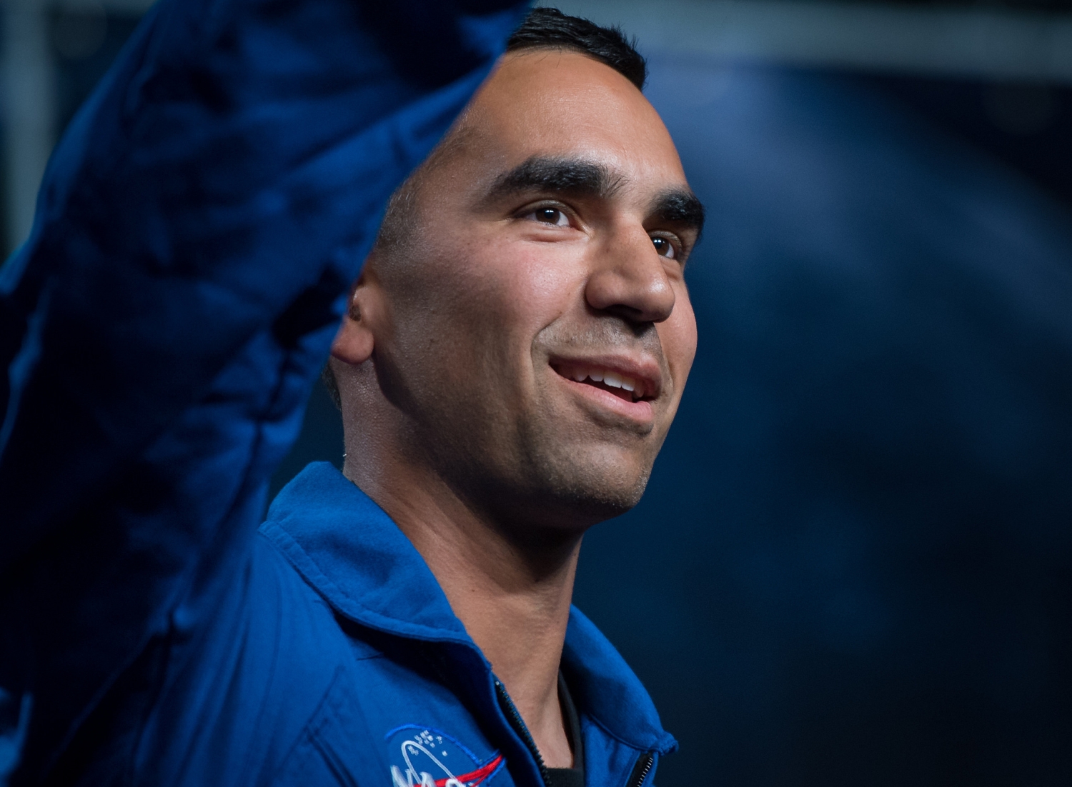 Thirty-nine-year-old NASA astronaut candidate Raja Chari waves as he is introduced as one of 12 new candidates at NASA.