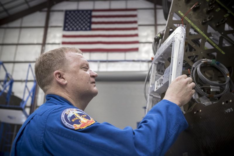 Commercial Crew Astronaut Eric Boe examines hardware during a tour of the SpaceX facility in Hawthorne, California. 