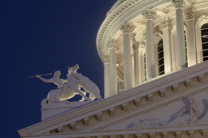 A night-time view of the California State Capitol building in Sacramento.