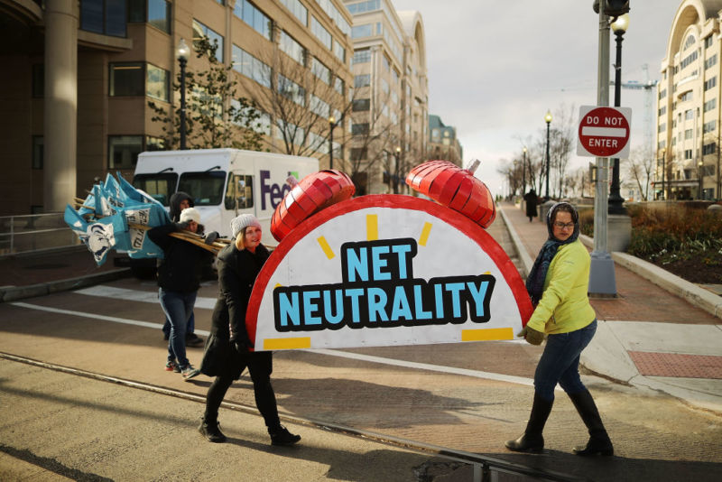 Net neutrality supporters holding a net neutrality sign outside the Federal Communications Commission building.