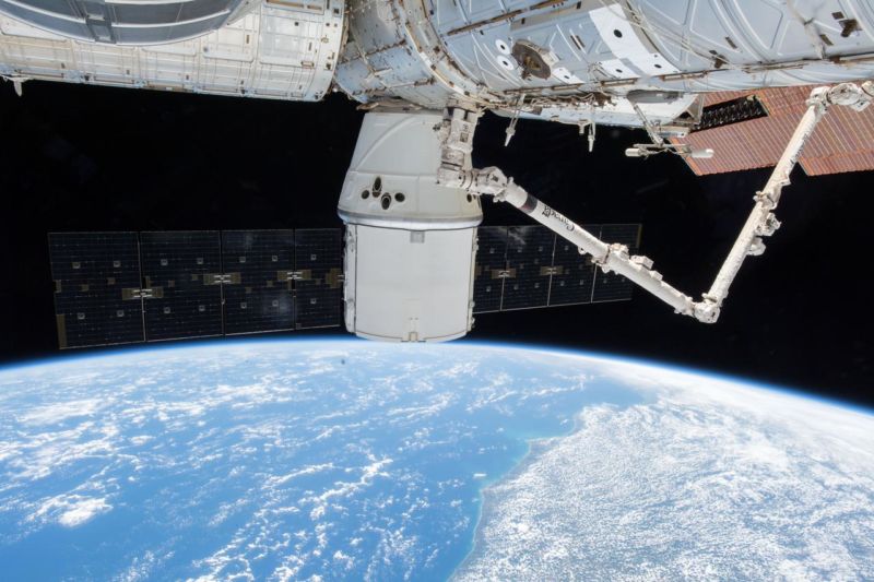 A SpaceX Dragon resupply ship with its dual outstreched solar arrays is pictured attached to the Harmony module as the International Space Station orbited above Brazil this month.