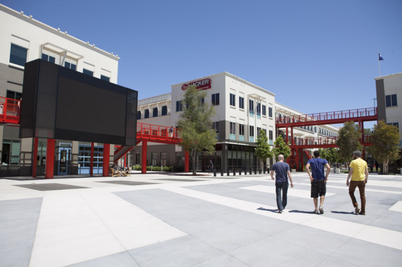 Scenes of daily work and life at Facebook, Inc. USA Headquarters in Menlo Park, California. Facebook employees and visitors walk along the main "Hacker Way" pathway between the buildings.