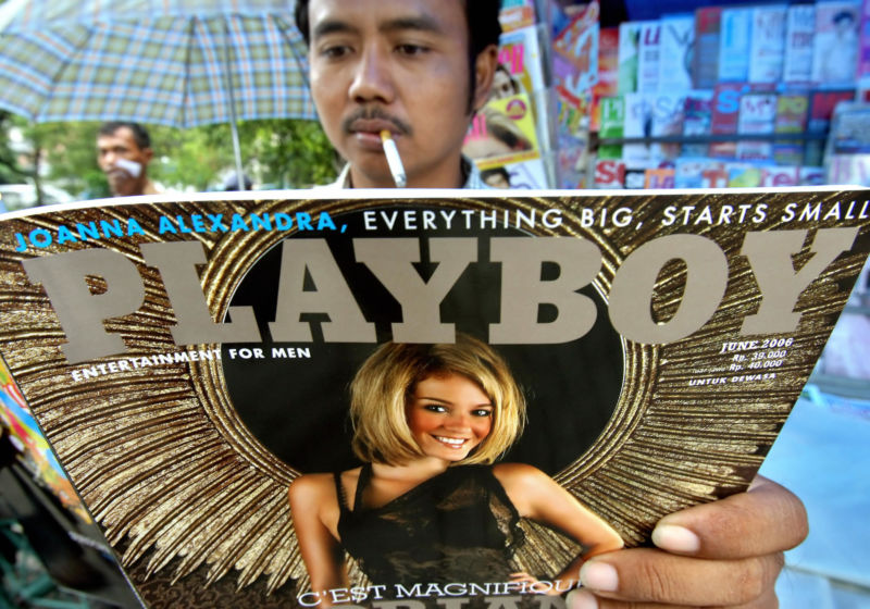 A man reads a copy of the second issue of the Indonesian edition of US adult magazine <em>Playboy</em> at a news-stand in downtown Jakarta in June 2006.