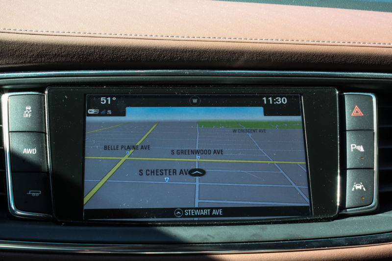 The regular GPS of a Buick Enclave. The buttons around the display, from top right: hazard, park assist view, lane-keep assist, towing, AWD activation, and traction control.