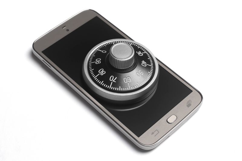 A combination padlock sits on the top of a smartphone.