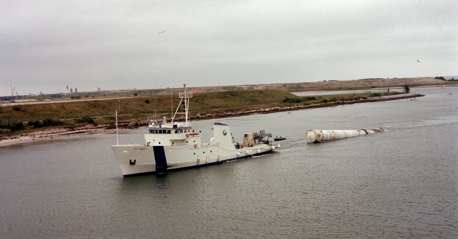 In 1982 the towing ship, Liberty, tows a recovered solid rocket booster from for the STS-5 mission to Port Canaveral, Florida. 