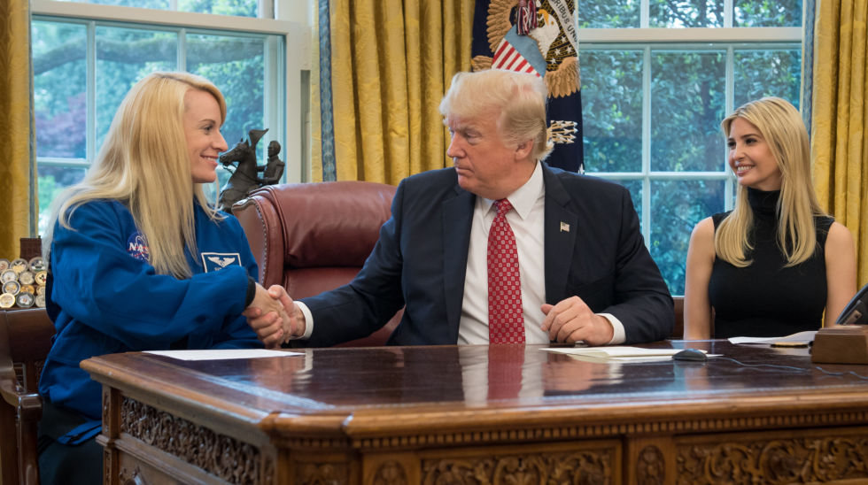 President Donald Trump shakes hands with NASA astronaut Kate Rubins, as First Daughter Ivanka Trump looks on, during a 2017 ceremony in the Oval Office.
