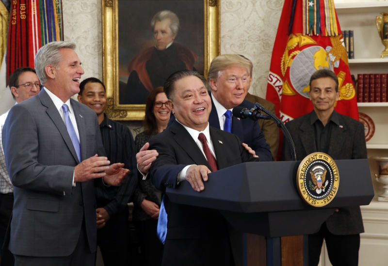 U.S. President Donald Trump hugs Broadcom CEO Hock Tan as Tan announces the repatriation of his company's headquarters to the United States from Singapore during a ceremony in the Oval Office of the White House on November 2, 2017 in Washington, DC. 