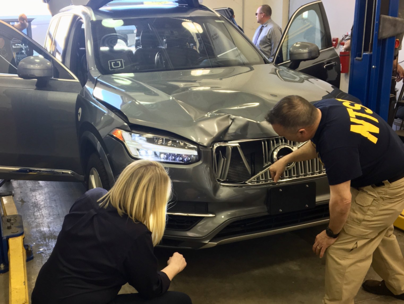 NTSB officials inspecting the vehicle that killed Elaine Herzberg in a March crash in Arizona.