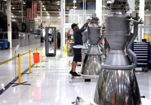 A SpaceX worker: young, wearing a hat, possibly listening to tunes.