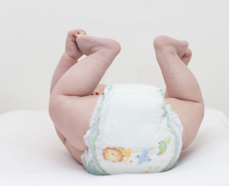 A view of a baby's behind, covered by a diaper