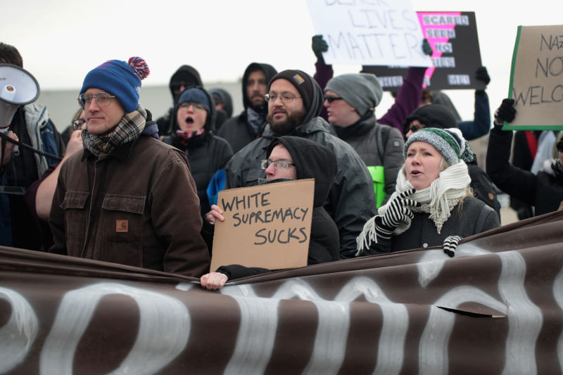 Demonstrators protest outside of a speech by white nationalist Richard Spencer, who popularized the term "alt-right," at Michigan State University on March 5, 2018.