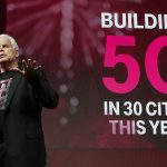 T-Mobile CTO Neville Ray speaking to an audience in front of a slide that says, "Building 5G in 30 cities this year."