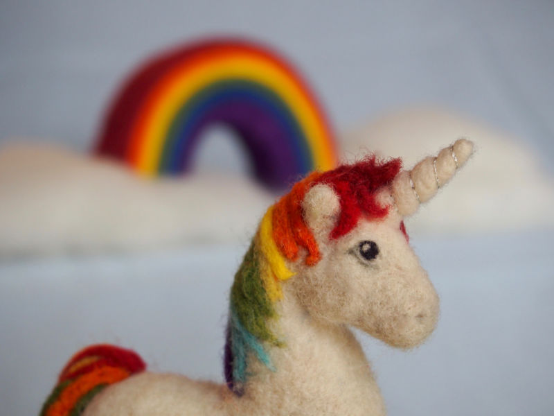 Unicorn with a rainbow in the background