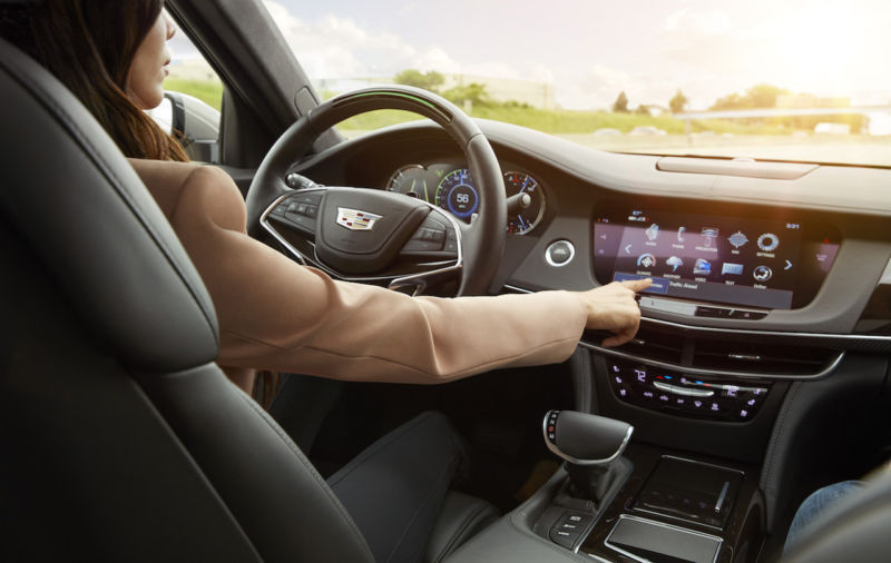 A woman sitting in a Cadillac CT6