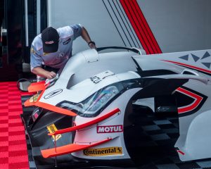 A Penske mechanic cleans one of the race cars