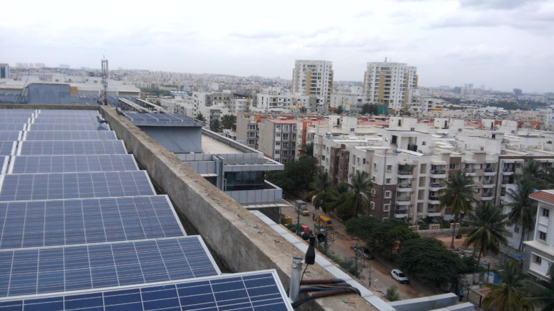 Rooftop solar panels overlooking an urban area.