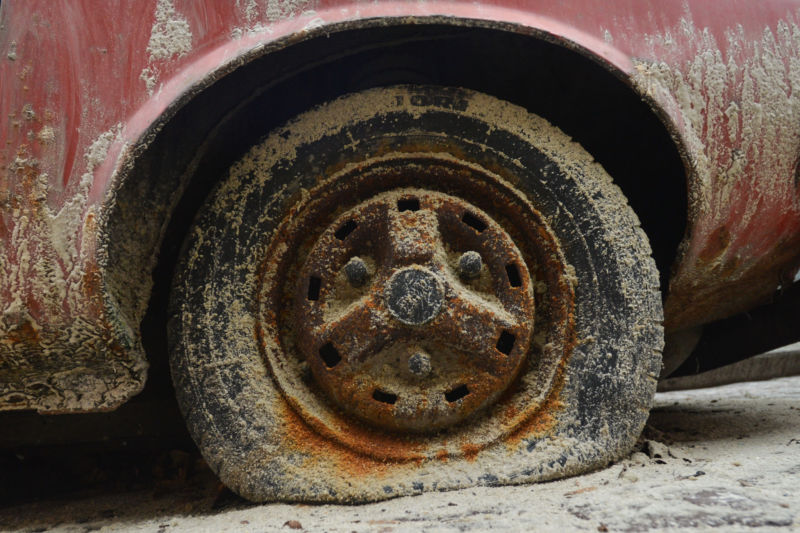 A tyre of an old Dacia 1310 parked in Lviv's city center, an example of a car dating the Soviet Union era.