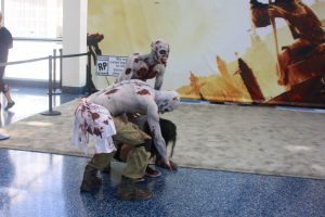 Two costumed zombies attack a woman