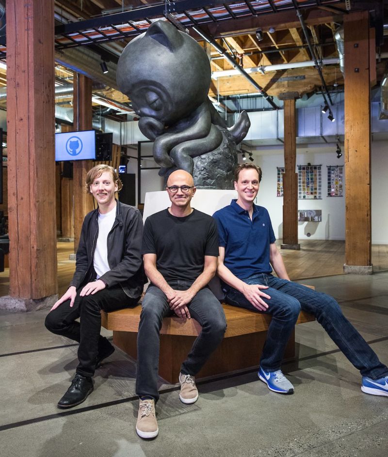 Men in artificially casual Silicon Valley garb pose for a picture.