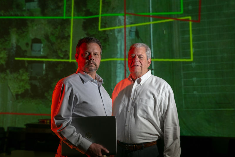 Vizaline owners Scott Dow and Brent Melton (right), standing in front of a sample Viza-plat property outline.