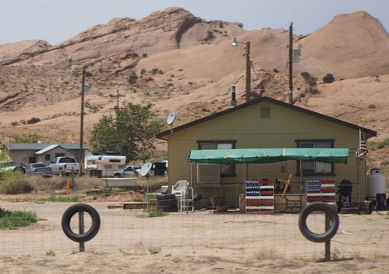 A small house with satellite dishes on a Navajo reservation.