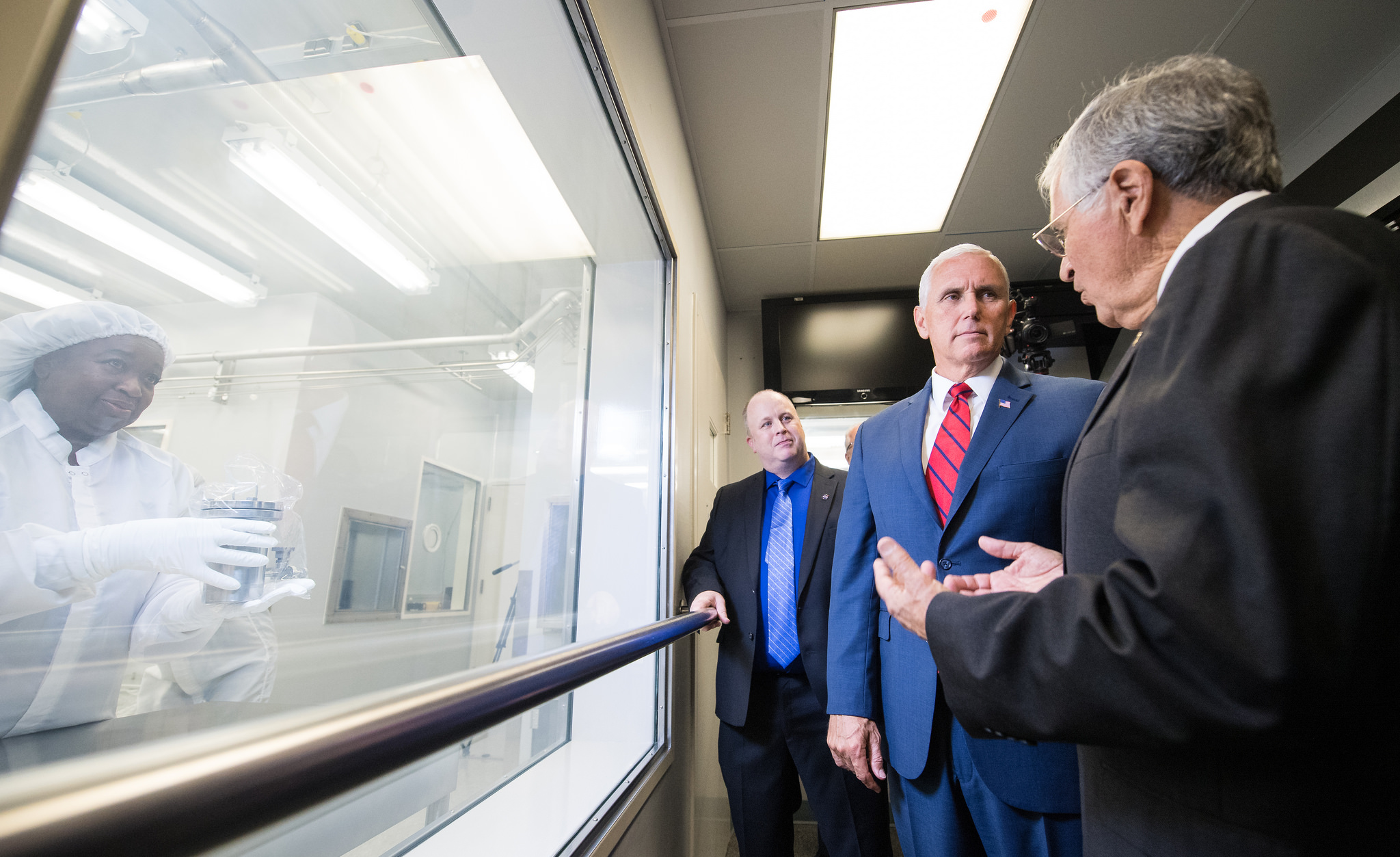 Pence views Sample 15014, which was collected during Apollo 15, with NASAs Apollo Sample Curator Ryan Zeigler, left, and Apollo 17 astronaut Harrison Schmitt, right, in Lunar Curation Laboratory at NASAs Johnson Space Center, Thursday.