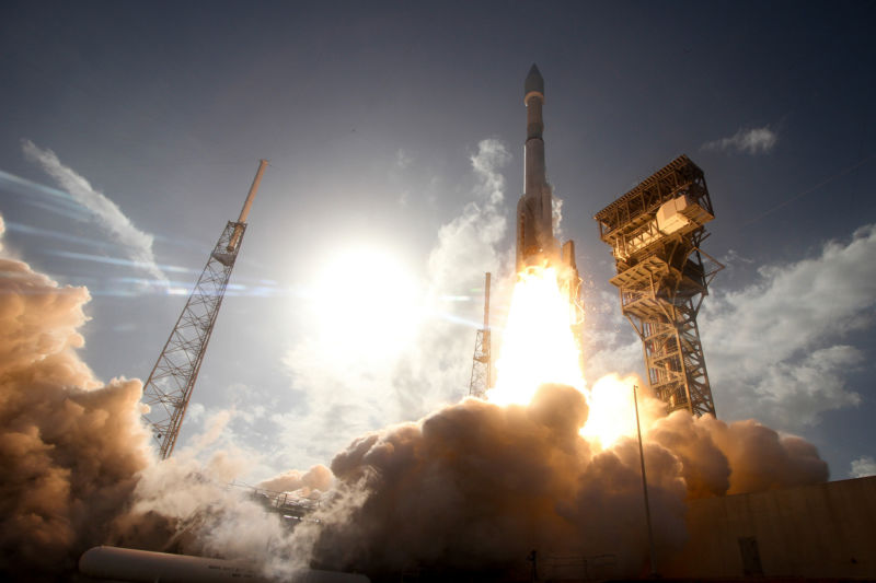 An Atlas V rocket lifts off in 2016, powered by a single RD-180 engine and solid rocket boosters.